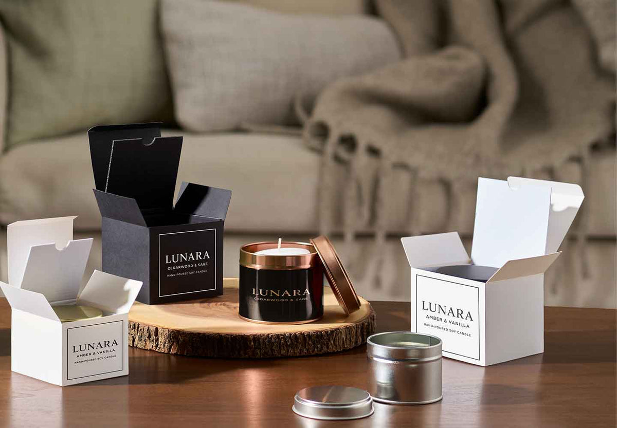 Selection of gift boxes with candle tin packaging in living room