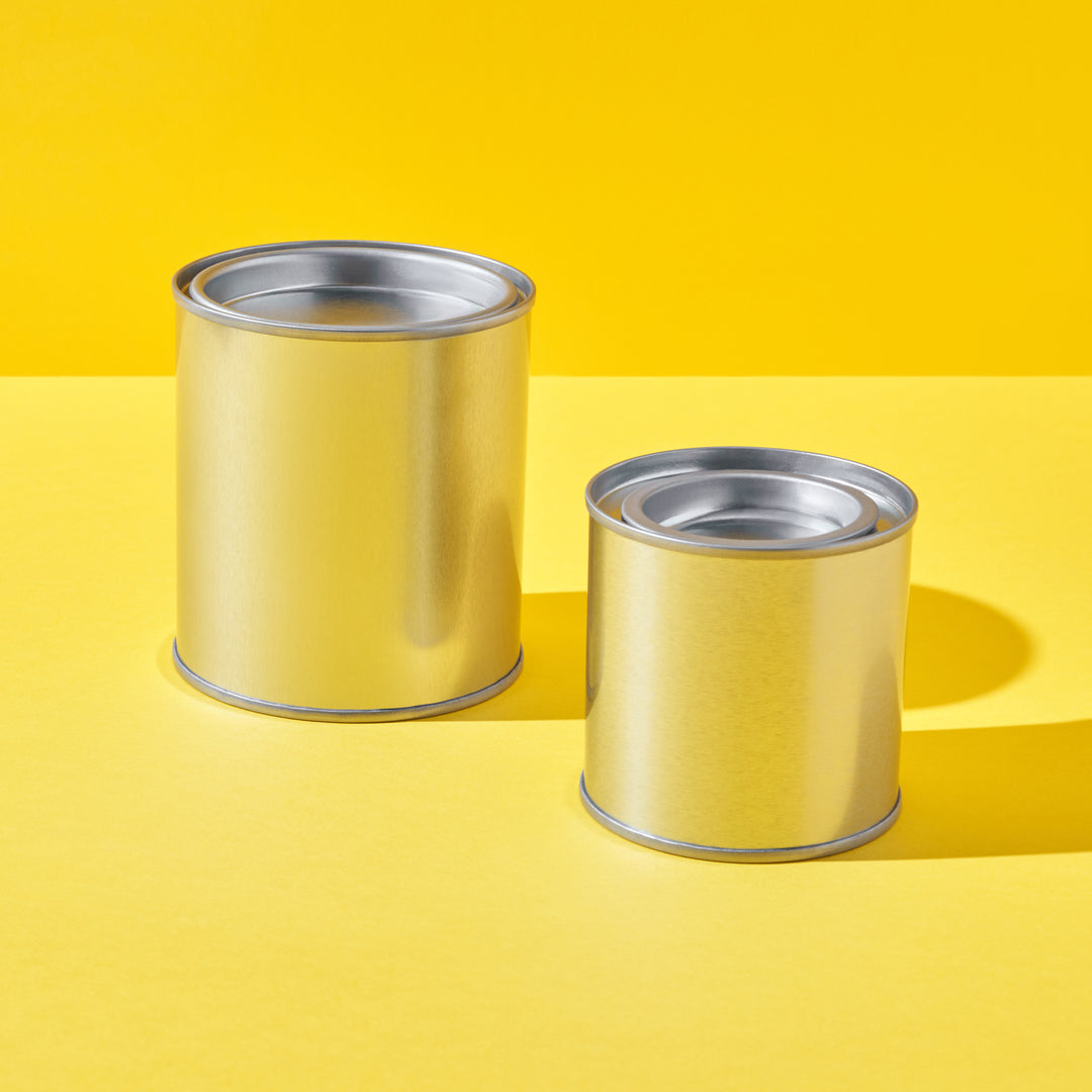 Two different sized small tins in a paint pot style in silver.