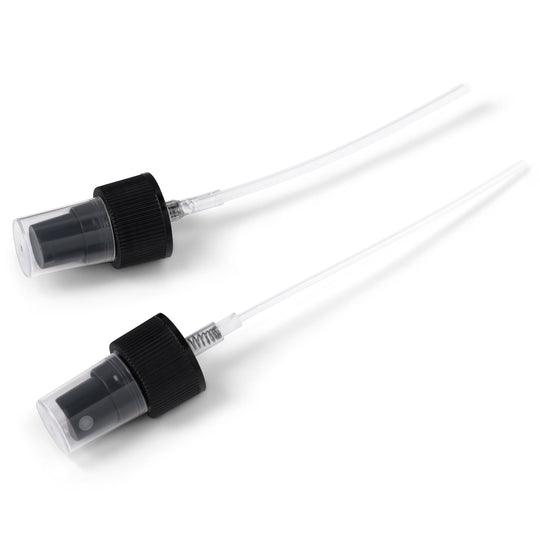 Black pump and spray caps on a white background. 
